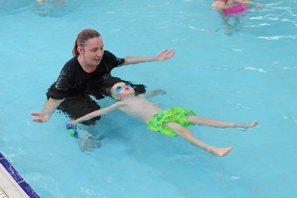 Swim Teacher instructing pupil in star float