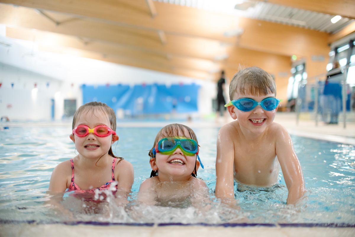 3 young children swimming