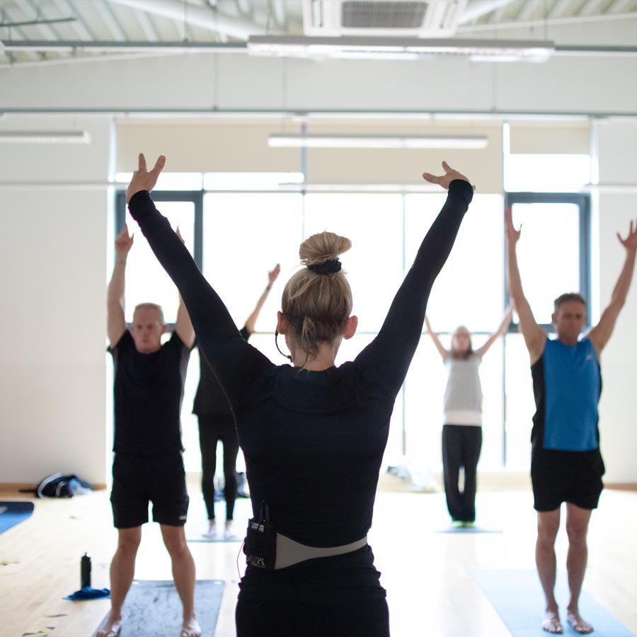 Yoga class holding a Yoga pose